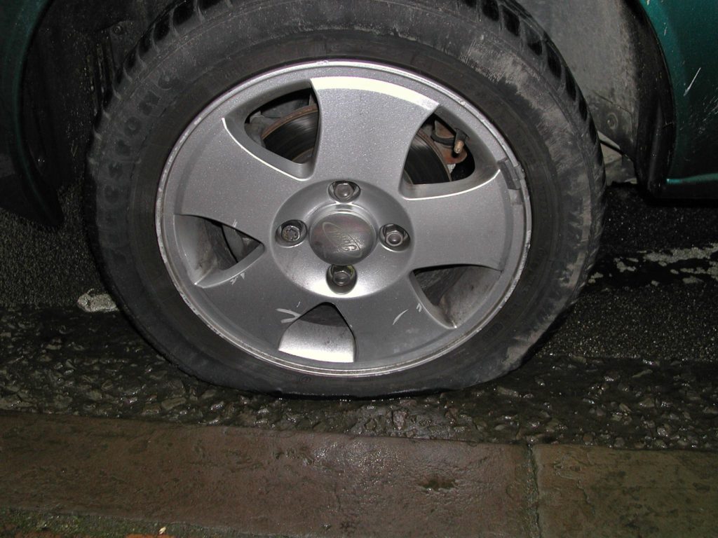 Woman's Tyre Bursts On SLE Near Midnight, 3 Lads Brave Downpour To Help Her