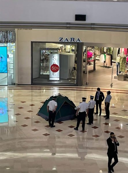 A woman walks past the Louis Vuitton shop in the Suria KLCC