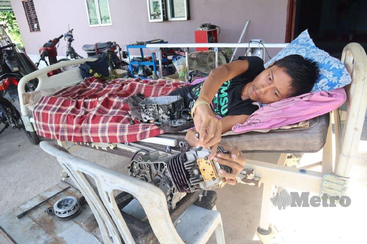 paralysed fixes motorcycles bed