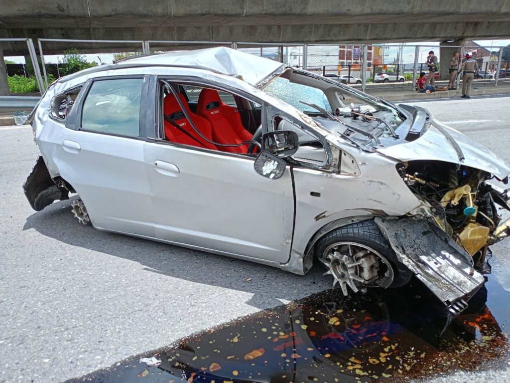 Car in Thailand squeezes through gap in traffic, falls off highway