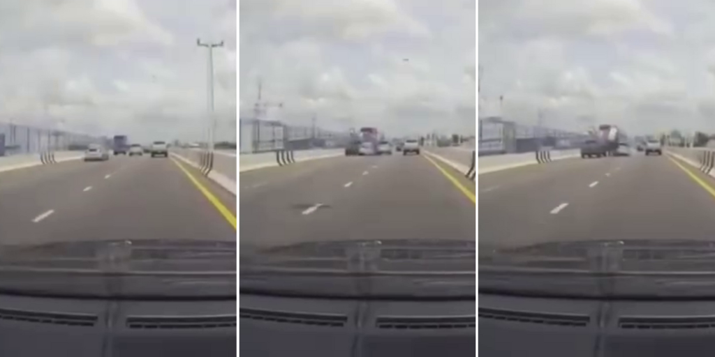 Car in Thailand squeezes through gap in traffic, falls off highway