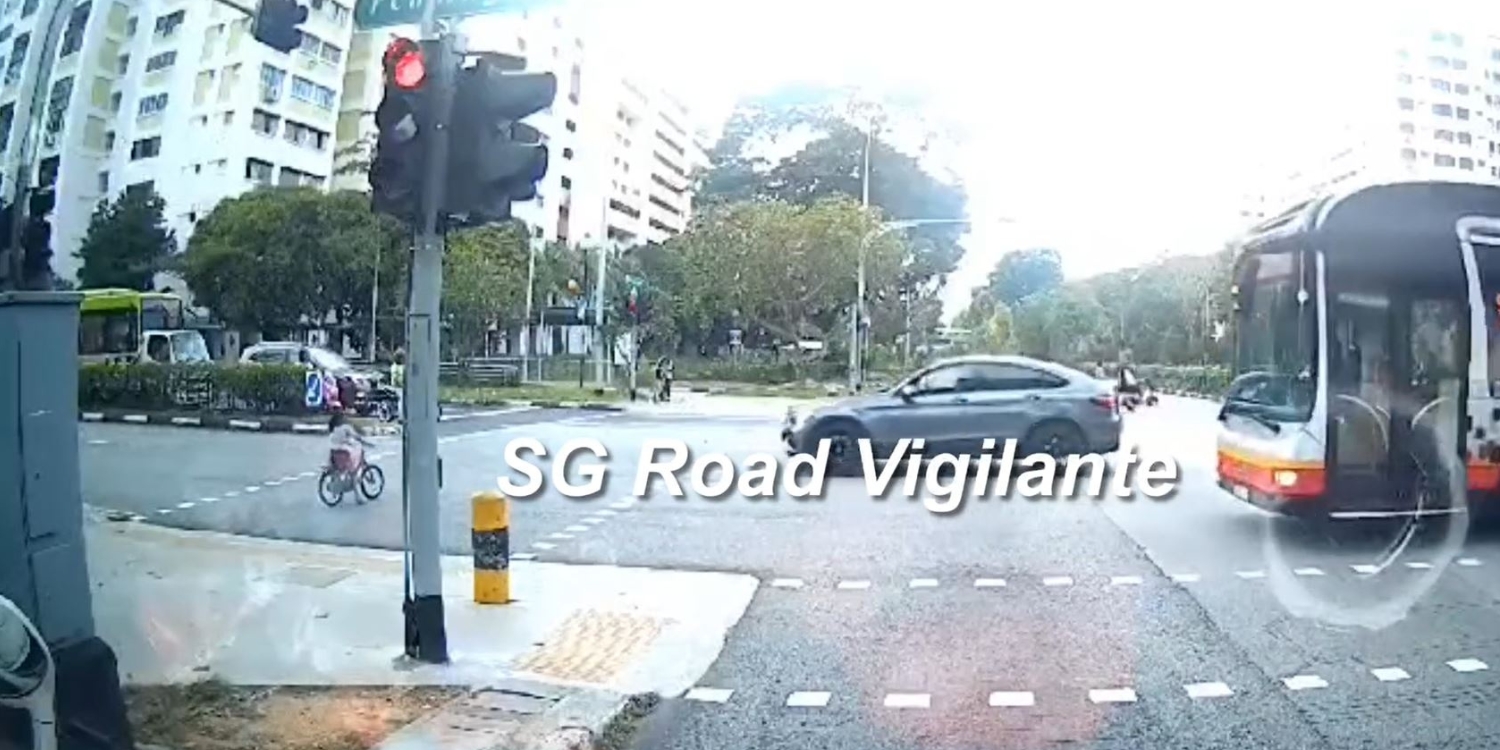 Young girl rides bicycle onto busy Bukit Panjang Road despite red pedestrian light, vehicles stop in time