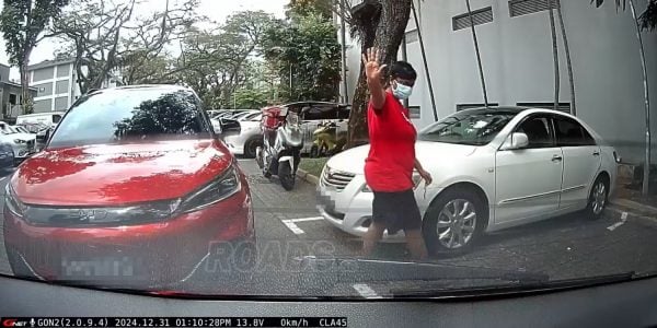 AMK parking spot allegedly gets stolen, passenger stands on lot to block car