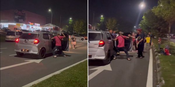 man punches female driver