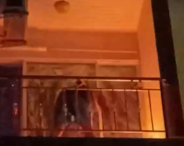 man balcony extinguish fire