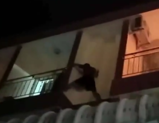 man balcony extinguish fire
