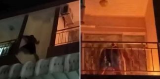 man balcony extinguish fire