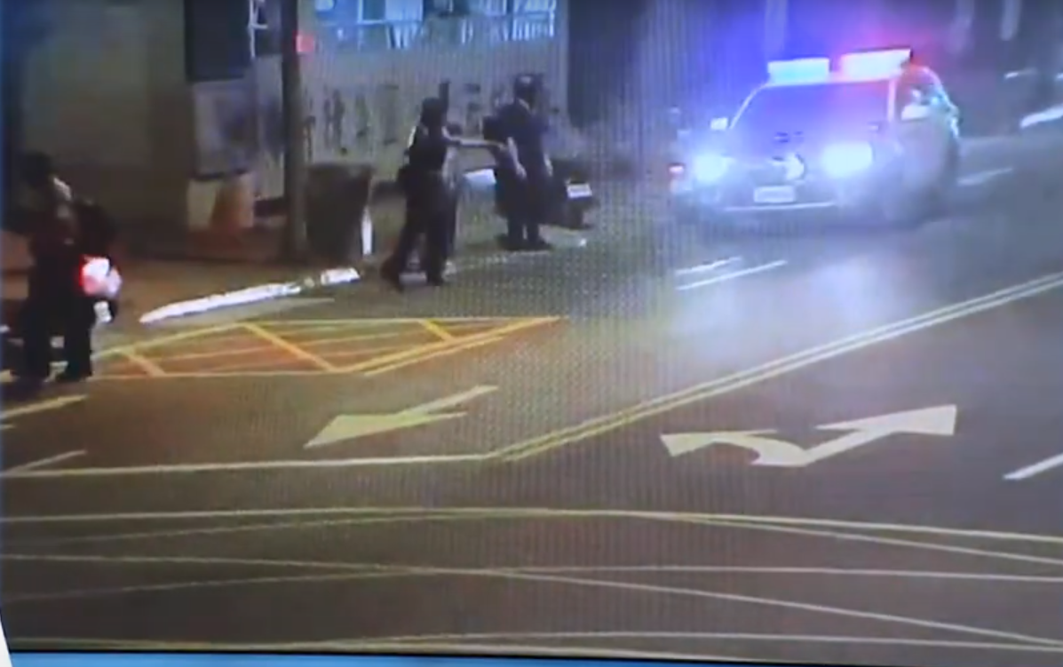 man flashes young woman