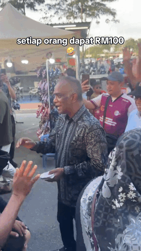 businessman gives away money beach (1)