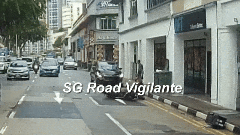 man helping motorcyclist