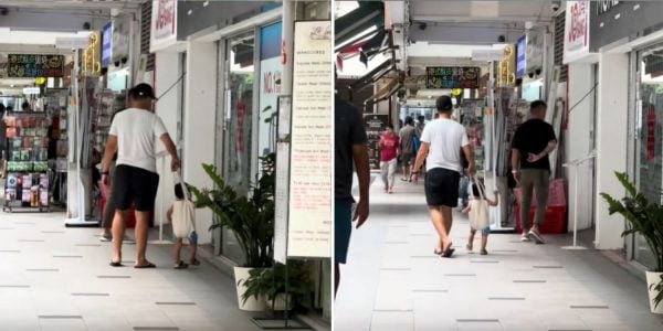 father and child in tote bag