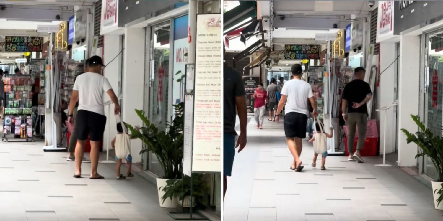 father and child in tote bag