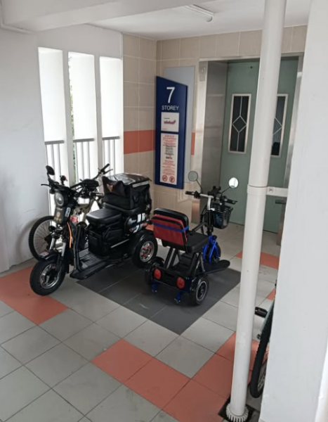 two personal mobility aids parked in front of lift