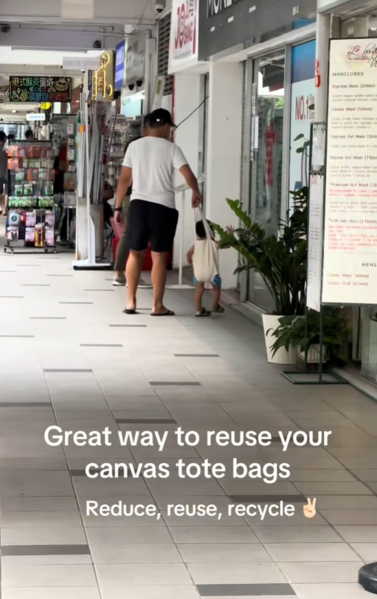 father and child in tote bag