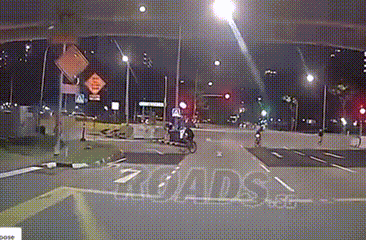 cyclist cycling towards slip road