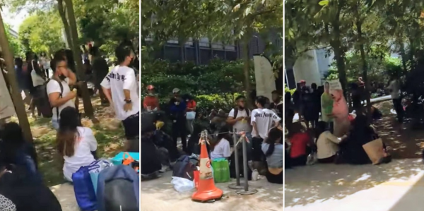 Migrant workers gathering by sidewalk