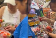 woman swaps strawberries with bare hands in FairPrice outlet at Bedok Mall