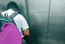 boy turns away eat elevator