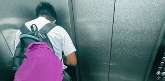 boy turns away eat elevator
