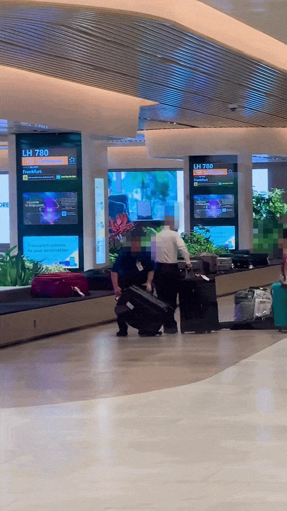 pushing luggage towards luggage belt