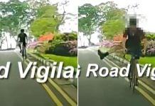 cyclist sticks leg out at car while riding against flow of traffic