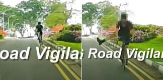 cyclist sticks leg out at car while riding against flow of traffic