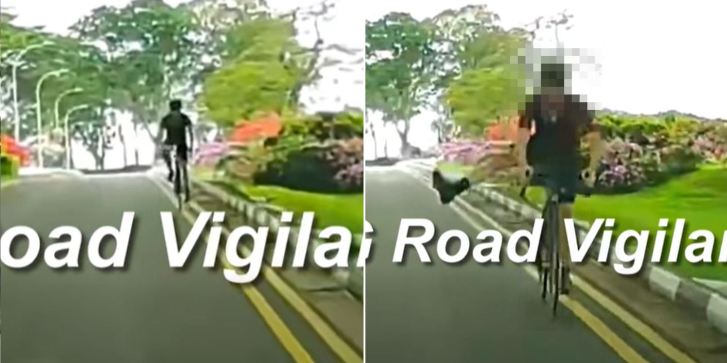 cyclist sticks leg out at car while riding against flow of traffic