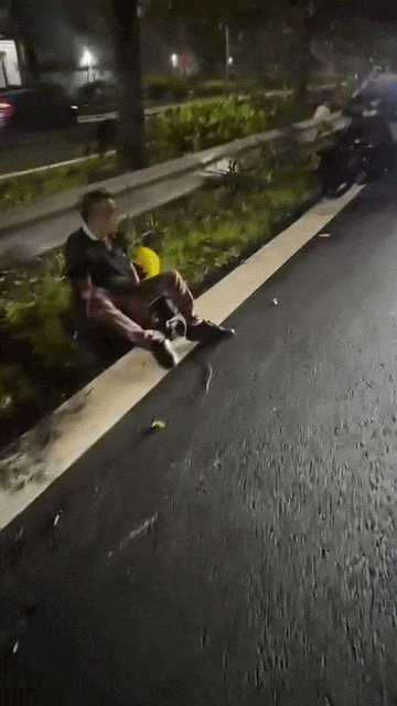 riders sitting on road shoulder